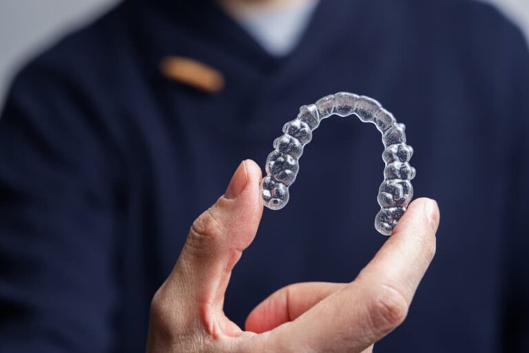 man holding one transparent aligner invisalign or 2023 02 28 18 33 52 utc 1