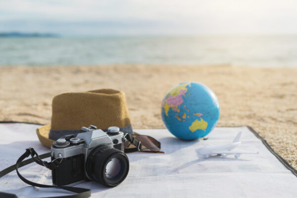 Camera, Hat and sunglasses on the beach, summer vacation