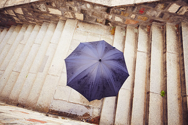 Rain in the city - Man with blue umbrella